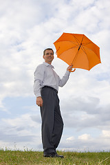 Image showing Businessman with orange umbrella