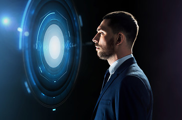Image showing businessman looking at virtual projection