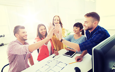 Image showing creative team making high five at office