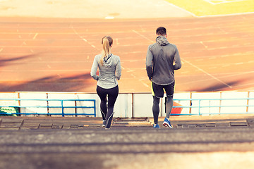 Image showing couple running downstairs on stadium