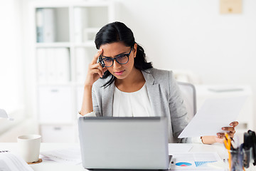 Image showing stressed businesswoman with laptop at office