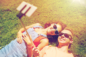 Image showing happy couple taking selfie on smartphone at summer