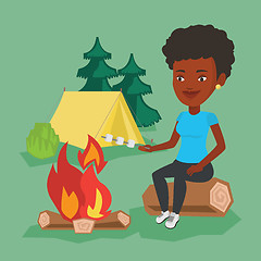 Image showing Woman roasting marshmallow over campfire.