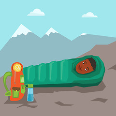 Image showing Woman resting in sleeping bag in the mountains.