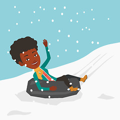 Image showing Woman sledding on snow rubber tube in mountains.