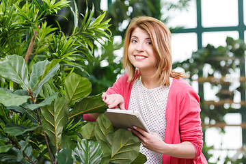 Image showing Young florist at flower shop