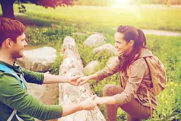 Image showing smiling couple with backpacks hiking