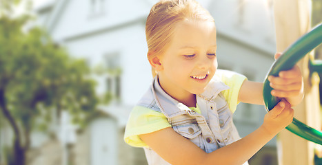 Image showing happy little girl climbing on children playground