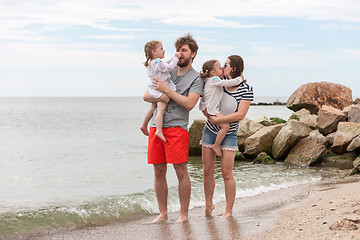 Image showing Family vacation parents and children on the sea shore summer day