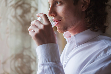 Image showing Man drinking water in studio