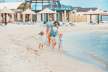 Image showing Family vacation parents and children on the sea shore summer day