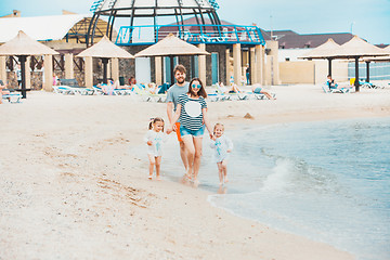 Image showing Family vacation parents and children on the sea shore summer day