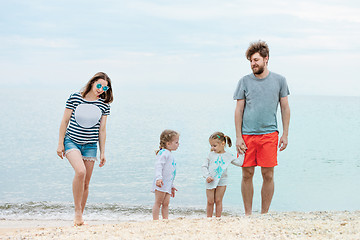 Image showing Family vacation parents and children on the sea shore summer day