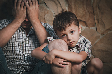 Image showing Portrait of sad son hugging his dad