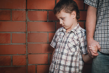 Image showing Portrait of sad son hugging his dad