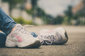 Image showing youth sneakers on girl legs on road 