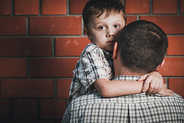 Image showing Portrait of sad son hugging his dad