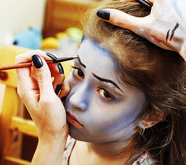 Image showing little cute child making facepaint on birthday party, zombie Apo