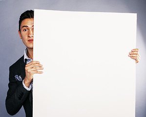 Image showing pretty cool european businessman holding empty white plate smili