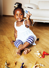 Image showing little cute african american girl playing with animal toys at ho