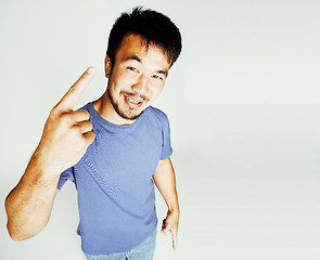 Image showing young cute asian man on white background gesturing emotional, po