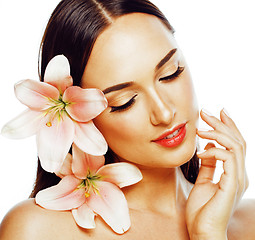 Image showing young attractive lady closeup with hands on face isolated flower