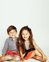 Image showing little cute boy and girl hugging playing on white background, ha