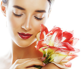 Image showing young pretty brunette real woman with red flower amaryllis close