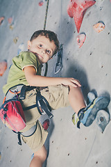 Image showing little boy climbing a rock wall