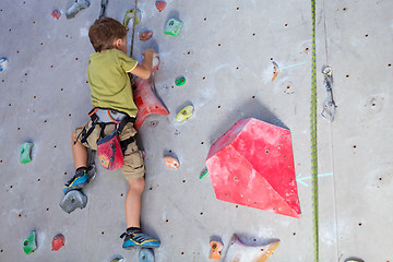 Image showing little boy climbing a rock wall