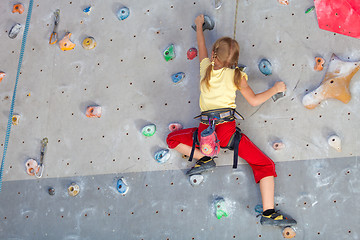 Image showing little girl climbing a rock wall