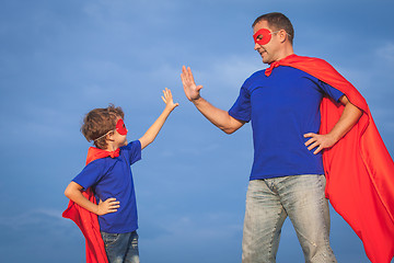 Image showing Father and son playing superhero at the day time. 