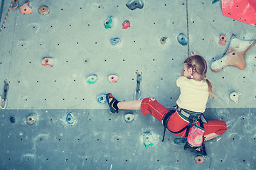 Image showing little girl climbing a rock wall