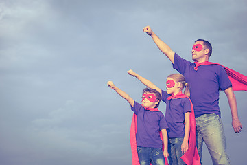 Image showing Father and children playing superhero at the day time.