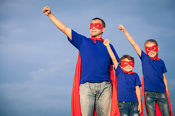 Image showing Father and children playing superhero at the day time.