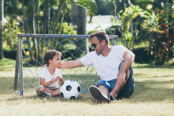 Image showing Father and son playing in the park at the day time.