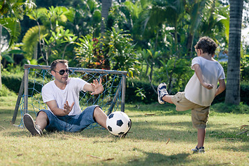 Image showing Father and son playing in the park at the day time.