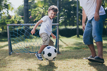 Image showing Father and son playing in the park at the day time.