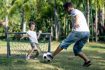 Image showing Father and son playing in the park at the day time.