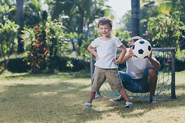 Image showing Father and son playing in the park at the day time.