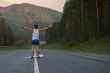 Image showing Man laying on the road