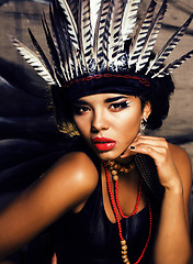 Image showing young pretty woman with make up like North American indian, feather in hair, fashion halloween concept creative