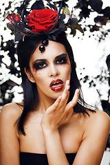 Image showing pretty brunette woman with rose jewelry, black and red, bright make up like a vampire closeup red lips, halloween concept