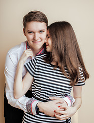 Image showing couple of happy smiling teenagers students, warm colors having a kiss, lifestyle people concept, boy and girl together 