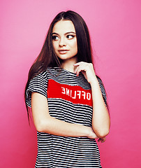 Image showing young pretty teenage woman emotional posing on pink background, fashion lifestyle people concept 