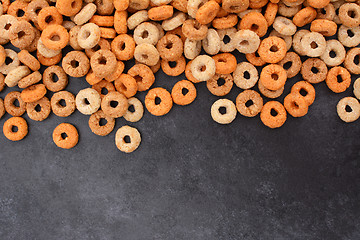 Image showing Multigrain hoops breakfast cereal border on dark grey slate