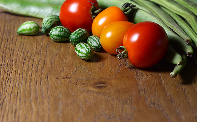 Image showing Cucamelons with red and orange tomatoes and runner beans