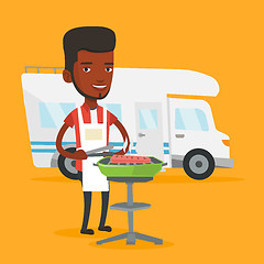 Image showing Man having barbecue in front of camper van.