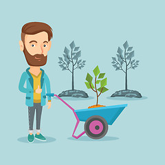 Image showing Man pushing wheelbarrow with plant.