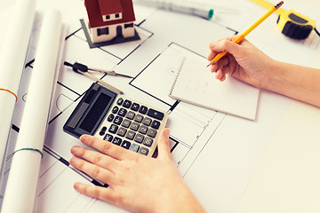 Image showing close up of architect hand counting on calculator